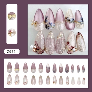 Purple flower press-on nails with 3D bows and pearls in a shimmering drop shape design