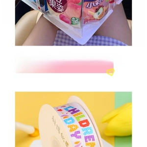 Close-up of Children's Day ribbon with rainbow lettering and hearts for gift wrapping