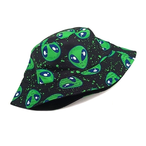Detail of street style black bucket hat with green alien print and paint splatter design