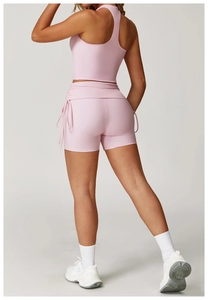 Detail of pink high-waisted gym shorts with drawstring and scrunch butt lifting effect