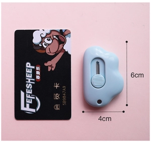 Detail showing 6cm mini cloud-shaped craft knife in light blue on pink background