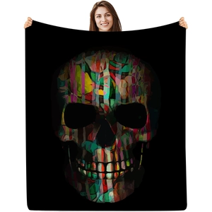 Close-up of a black flannel blanket with a colorful abstract skull art print