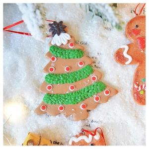 Macro shot of gingerbread man and tree ornaments with realistic icing texture