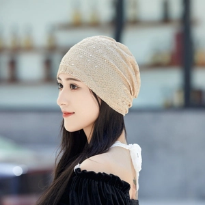 Detailed view of apricot lace beanie with sparkling rhinestone embellishments for women