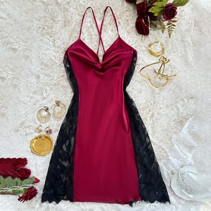 Elegant wine red satin nightgown with black lace trim and cowl neck on white rug