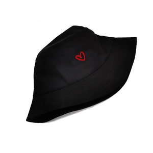 Close-up of red heart embroidery on the front of a black cotton bucket sun hat
