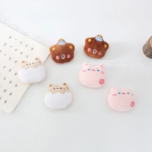 Macro detail of assorted plush animal brooches with cute embroidery for bags and clothes