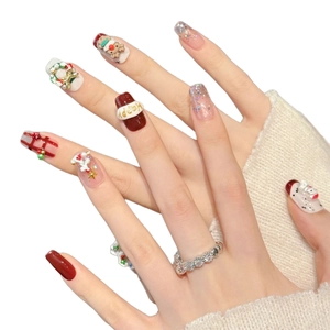 3D Christmas press-on nails featuring red glitter, festive deer, and snowman designs