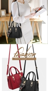 Detail of crossbody bag with V-shaped woven texture, fur ball charm and LOVE strap
