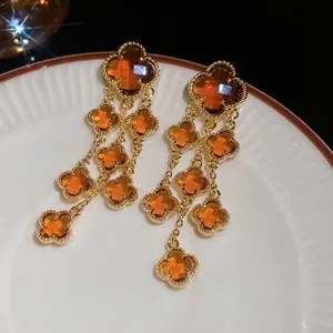 Gold plated long flower tassel earrings with amber crystals and four-leaf clover motifs