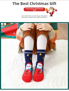 Close-up of navy blue children's Christmas socks with Santa Claus patterns and red accents