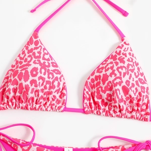 Flat lay detail of pink leopard print bikini set with size S tag and drawstring ties