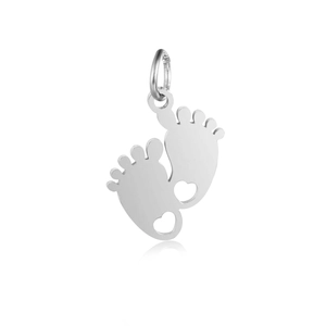 Detailed view of baby footprint pendant with hollow heart cutout and polished silver finish