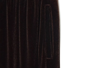 Detail of side pocket on brown velvet trousers with soft texture and rich sheen