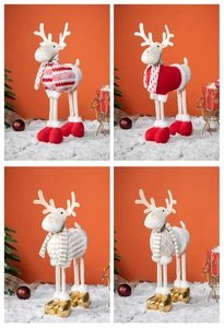 Close-up of four plush Christmas reindeer dolls with festive sweaters and long legs