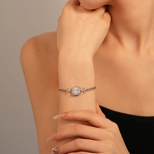 Macro detail of elegant Cuban chain bracelet with square zircon stone and side baguettes