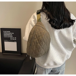 Model view of army green quilted crossbody chest bag with adjustable strap and casual style