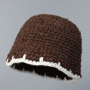 Detail of thick knit brown beanie with white hand-stitched decorative edge trim