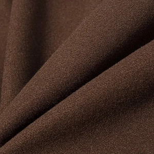Detailed macro view of dark brown wool fabric texture on long coat with fringe trim