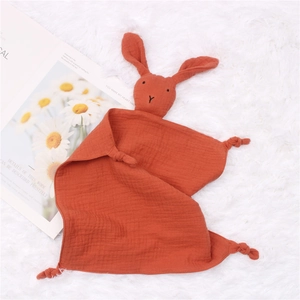 Close-up of caramel cotton muslin baby security blanket with knotted rabbit head detail