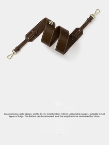 Caramel leather shoulder strap detail with gold hardware and adjustable length settings