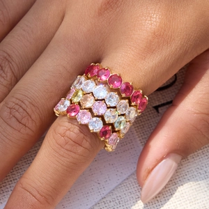 Stacked gold stainless steel rings featuring multi-color round-cut zircon gemstones