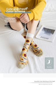 Detail of sheer glass silk socks with sunflower embroidery and breathable mesh texture