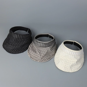 Detailed view of mesh sun hats with pearls in black, grey, and white colors