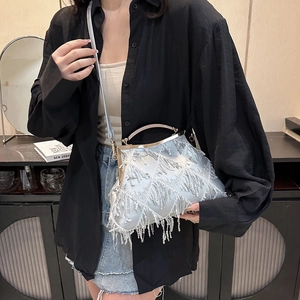 Silver fringe tassel evening bag with shiny sequins and vintage clasp shown on a shoulder