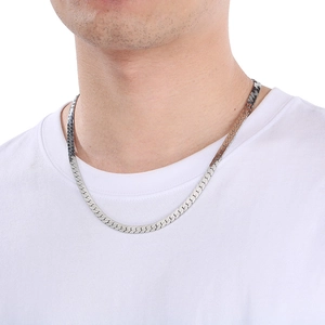 Close-up of flat silver stainless steel snake chain necklace worn by a male model