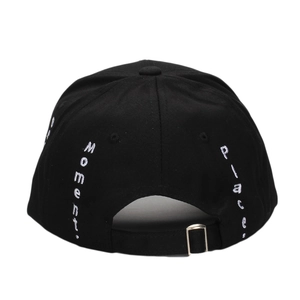 Rear view of black cotton baseball cap with white Moment embroidery and metal buckle