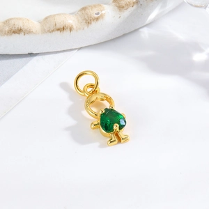 Detailed view of a gold-tone girl pendant with an inlaid green faceted gemstone charm