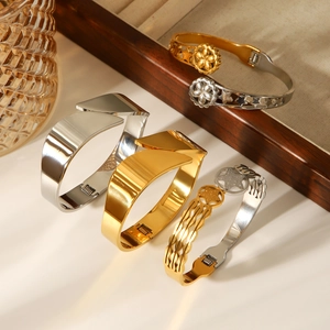 Minimalist gold and silver stainless steel star bangles with a wide geometric open design