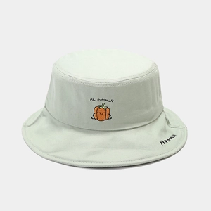 Detailed close-up of a mint green canvas bucket hat featuring cute pumpkin embroidery