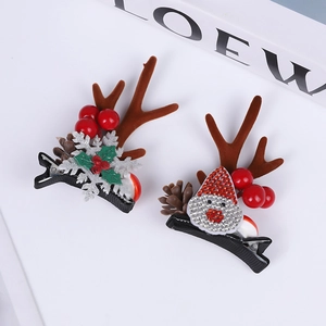 Detail of plush reindeer antler hair clips with sequins and holly leaf decorations