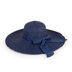 Detail of navy blue straw sun hat featuring elegant bow ribbon and wide brim texture