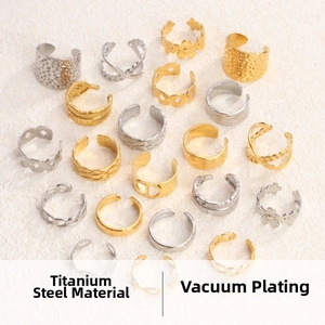 Detailed macro view of assorted titanium steel open rings with vintage patterns and gold plating
