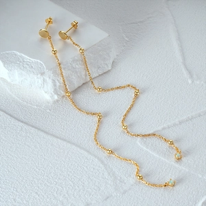 Detail of S925 sterling silver gold fringe earrings with opal stone and beads