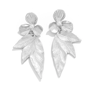 Detail of silver ginkgo leaf earrings with flower studs and white pearl accents