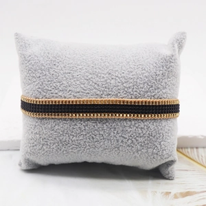 Minimalist gold and black Miyuki bead woven bracelet on a grey velvet jewelry display pillow