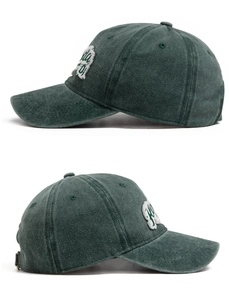 Detail view of washed cotton baseball cap with vintage embroidery and metal buckle