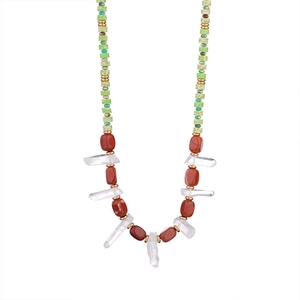 Bohemian natural stone necklace with red gems, turquoise beads and gold spacers on white