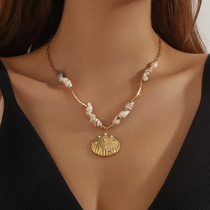 Bohemian gold-plated necklace featuring a shell pendant with pearls on a model