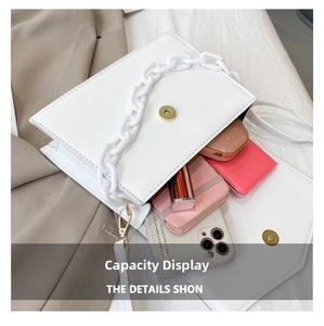 Internal view of white crossbody bag showing storage space for phone and makeup