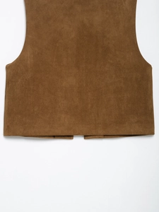 Detail shot of the back hem on a brown suede vest with fine texture and stitching