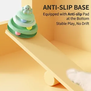 3-tier cat turntable toy with octopus topper and colorful balls on warm background