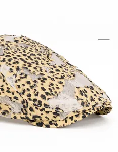 Detail showing foldable curved brim and leopard lace pattern on a stylish flat cap
