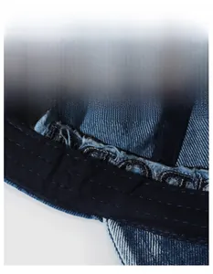 Close-up of the widened sweatband and inner stitching of the washed denim baseball cap