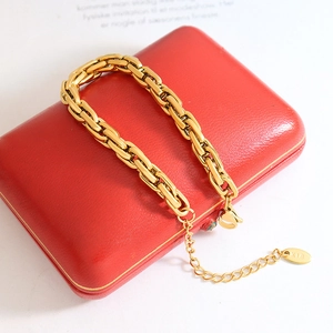 Vintage chunky gold chain bracelet with K18 tag on a red jewelry gift box