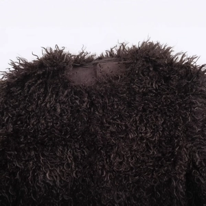 Deep brown faux fur coat showing thick curly texture and soft premium plush material